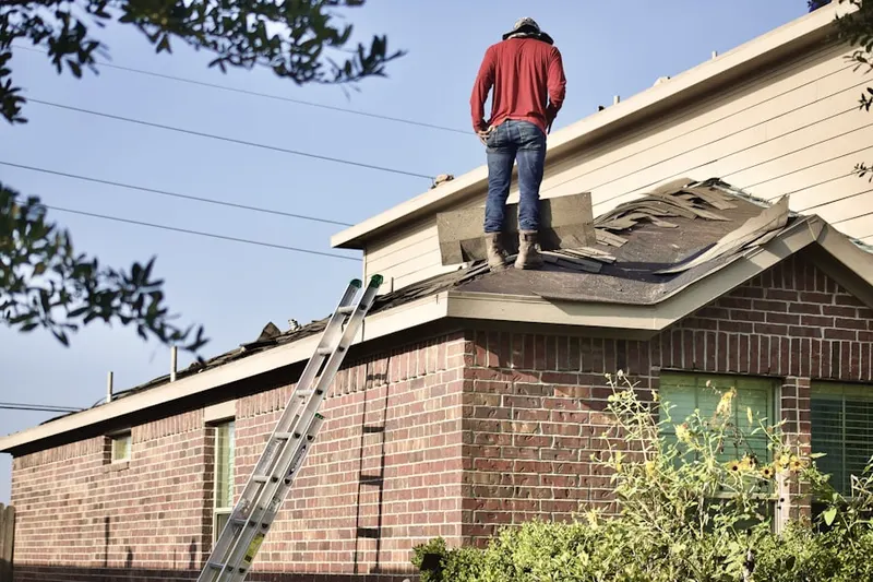 Professional roofer working on a residential roof in Daisytown
